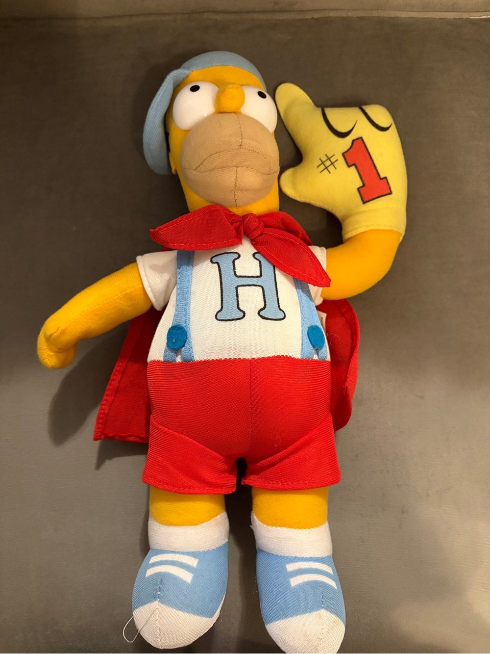 Homer Simpson Dressed In A Superhero Cape Blue Cap & Giant #1 Hand